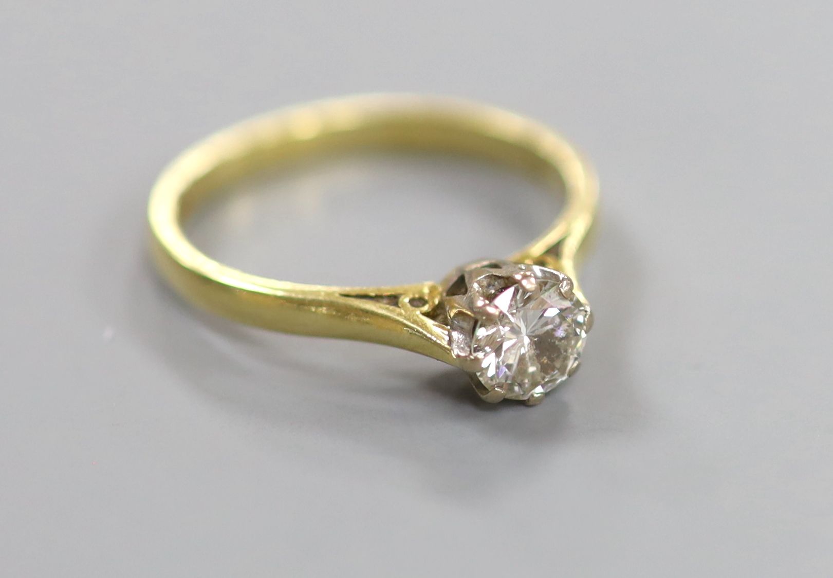 A modern 18ct gold and solitaire diamond ring